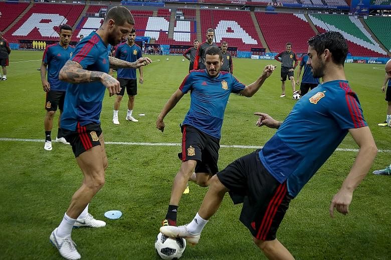 From left: Spain captain Sergio Ramos and midfielders Koke and Isco having a kickabout during training ahead of today's Group B decider against Morocco. La Roja are level with Portugal on four points, with Iran one behind.