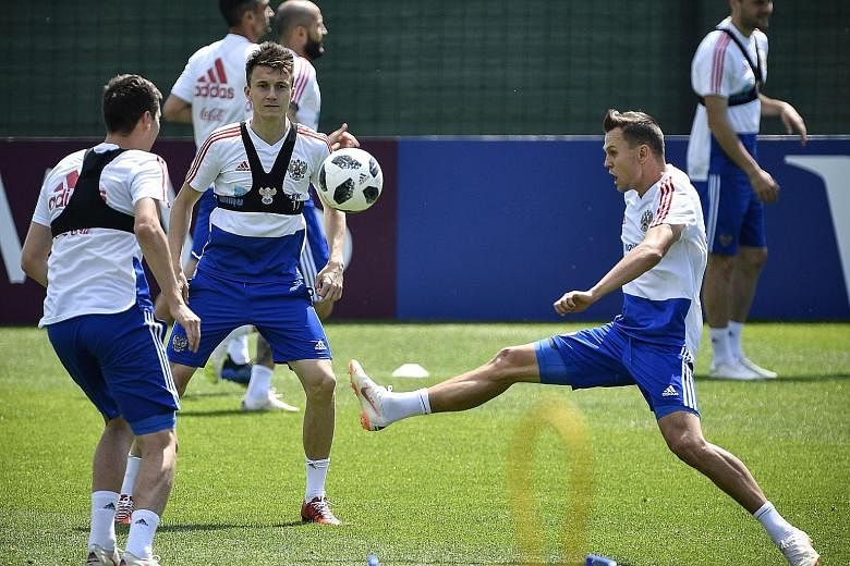 Russia's midfielders (from left) Daler Kuzyayev, Alexander Golovin and Denis Cheryshev during a training session in Novogorsk. As his side prepare to meet Uruguay, coach Stanislav Cherchesov has refuted suggestions that their success stems mainly fro
