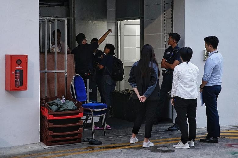 The body of the dead man being carried out of the Bedok South Road premises. The owner of Ng Kian Seng Confectionery died after he fell into a dough-making machine while preparing red bean paste. Investigations under way at Thyme Food and Services on
