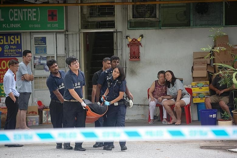 The body of the dead man being carried out of the Bedok South Road premises. The owner of Ng Kian Seng Confectionery died after he fell into a dough-making machine while preparing red bean paste. Investigations under way at Thyme Food and Services on