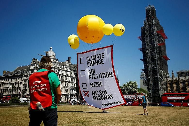 A protest in Britain against the expansion of Heathrow airport yesterday. Approving the project has taken 50 years and is still far from over. Activists worry about its environmental impact.