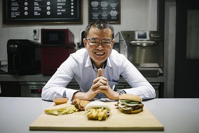 Mr Eric Er, vice-president of operations for No Signboard Holdings' new Hawker quick service restaurant, says the chain's burgers will feature flavours such as chilli crab, satay and chicken rice.