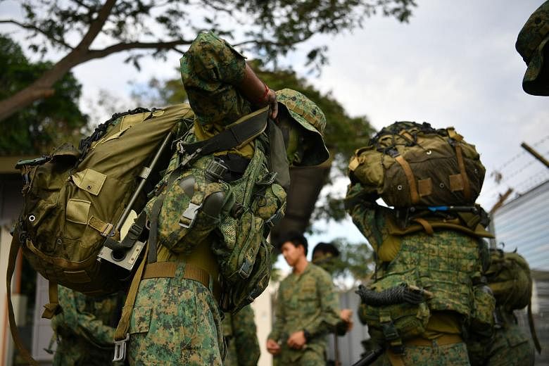 Commandos putting on their field packs. An example of a potentially disruptive military technology highlighted by the writer would be advanced materials with adaptive properties that can make military equipment lighter as well as more weather-resista