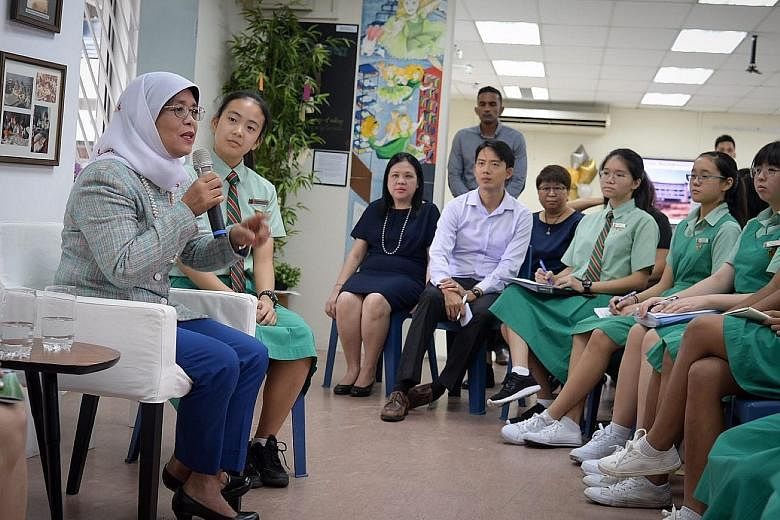 President Halimah Yacob at her alma mater, Tanjong Katong Girls' School, yesterday. She answered students' questions on what it takes to be a good leader and how they can contribute to society. The dialogue was held in conjunction with the school's 6