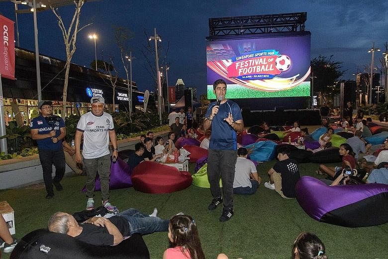 Comedian Rishi Budhrani entertaining football fans waiting for the live screening of a World Cup match at the Singapore Sports Hub.