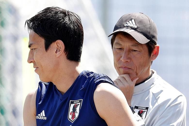 Japan head coach Akira Nishino, seen here with captain Makoto Hasebe during training, expects a tough match against Poland, knowing that the Poles do not want to go home losing all their three matches.