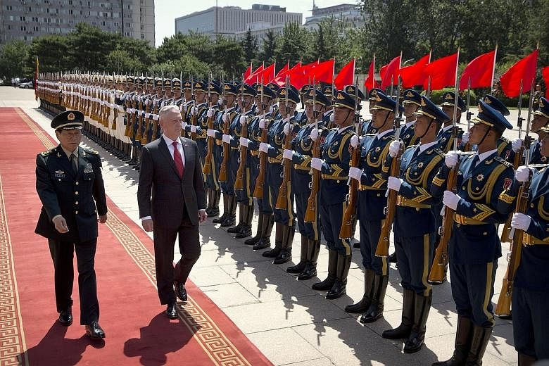 US Defence Secretary James Mattis reviewing an honour guard with China's Defence Minister Wei Fenghe during a welcome ceremony in Beijing yesterday. Describing Mr Mattis' visit as a "positive factor", General Wei made clear Beijing's position and con