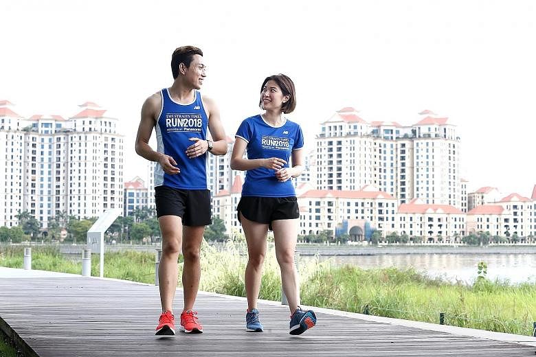 Straits Times multimedia journalists Hairianto Diman and Alyssa Woo donning the men's and women's race vests (left), and the finishers' T-shirts.