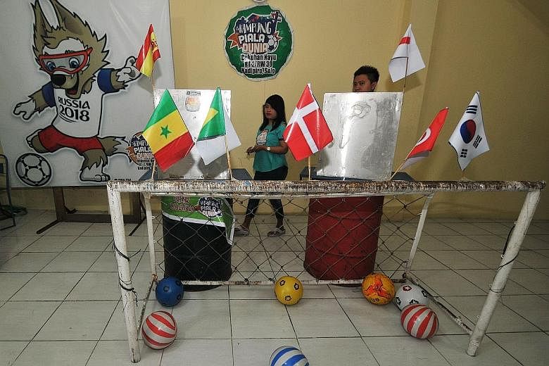 A polling station in Solo, Central Java, decorated with a football theme amid the ongoing World Cup in Russia. Over 150 million registered voters were set to elect their governors, mayors and regents in yesterday's polls.