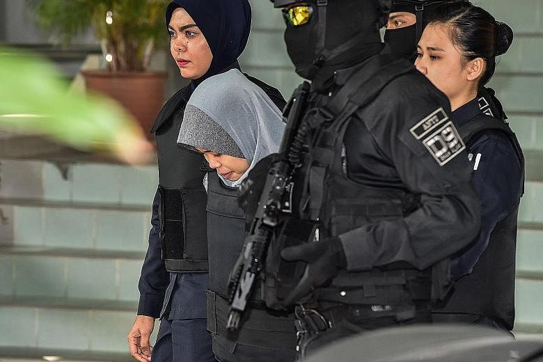 Vietnamese suspect Doan Thi Huong being escorted by Malaysian police after a court session for her trial at the Shah Alam High Court in Shah Alam, outside Kuala Lumpur, yesterday. She was allegedly involved in the assassination of Mr Kim Jong Nam, th