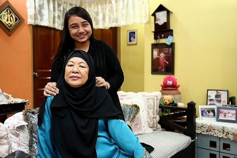 Madam Sulami Hassan, who suffered a stroke two years ago, and her daughter Noor Sheela Sani at their flat in Yishun. The GST vouchers will "help to lighten our financial burden", said Ms Noor Sheela, who also intends to use the Medisave top-ups to of