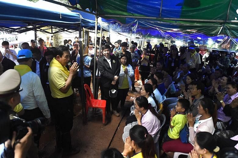 Thai Premier Prayut Chan-o-cha talking to relatives of the missing 13 yesterday.