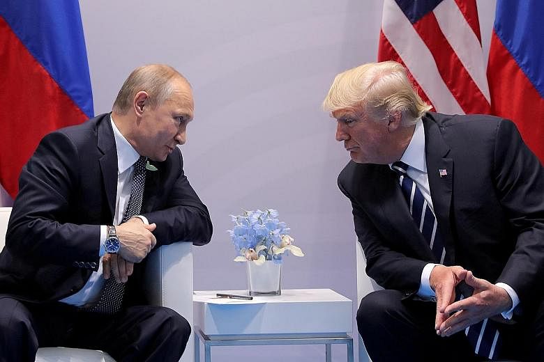 Russian President Vladimir Putin talking to US President Donald Trump during a bilateral meeting at the Group of 20 summit in Germany last July. The two leaders will meet again in Helsinki on July 16.