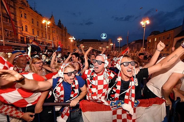 Croatian fans, wearing the national caps of their powerhouse water polo team, watching a giant screen in Zagreb's main square when their footballers took on Argentina on June 21.