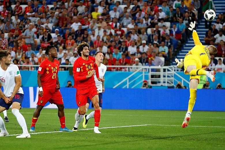 England goalkeeper Jordan Pickford diving in vain as Belgium's Adnan Januzaj (not in photo) scores the only goal in the match six minutes into the second half. Belgium will face Japan in the round of 16 on Monday, while England have Colombia to conte