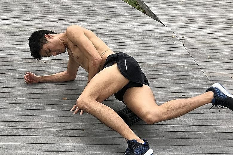 Mok Ying Ren using a foam roller to reduce muscle tightness and increase blood circulation. He stresses that the body needs sufficient time to recover or one will only get more tired.