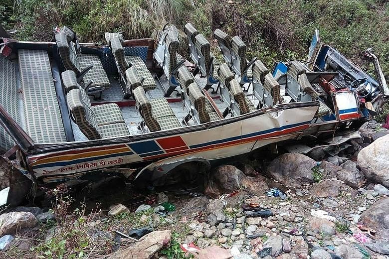 The twisted chassis of a passenger bus with the roof sheared clean off after it crashed into a gorge in northern India yesterday. At least 44 people were killed and three others injured, officials said. Search and rescue crews were at the crash site 