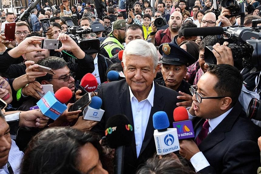 Presidential candidate Andres Manuel Lopez Obrador surrounded by a crowd at a polling station in Mexico City yesterday.