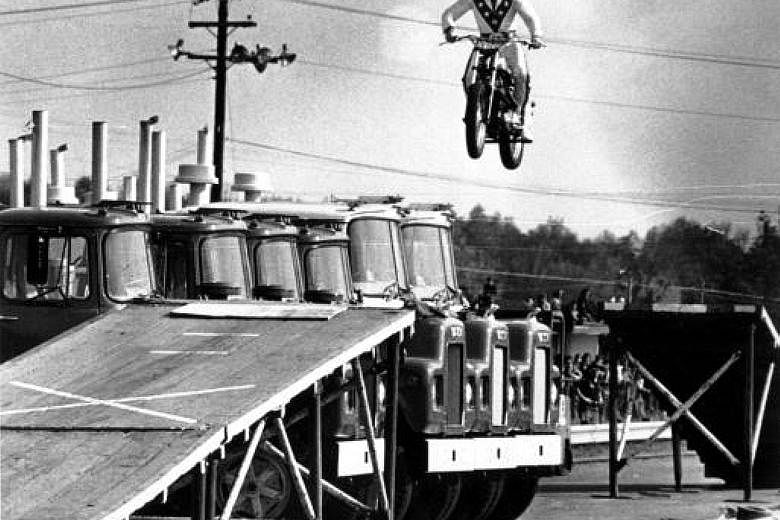 Evel Knievel jumping over 10 Mack trucks (left) at Dragway 42 in Cleveland in May 1974. The motorcycle daredevil (right) died in 2007.