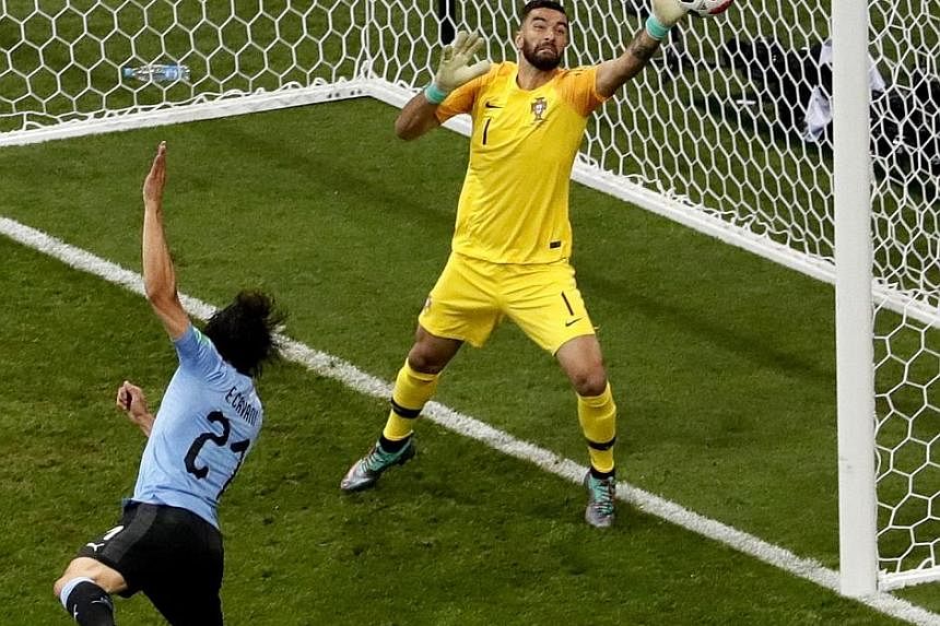 Left: Portugal's Cristiano Ronaldo is marked tightly by Uruguay midfielders Lucas Torreira (second from left) and Nahitan Nandez in Sochi on Saturday. Below: Edinson Cavani opening the scoring for Uruguay. He also netted the winner after Pepe's equal