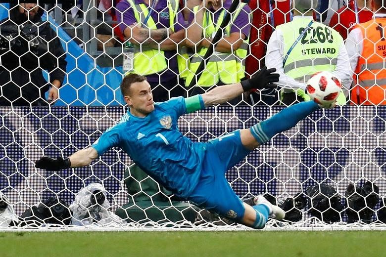 Russia goalkeeper Igor Akinfeev sticking out his foot to save a spot kick from Spain substitute Iago Aspas during the penalty shoot-out. It was his second save from Spain's five kicks, putting the hosts through 4-3 on penalties.