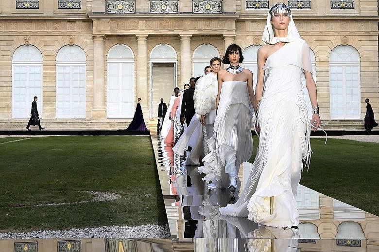 The haute couture show by Givenchy (above and below) was held in the gardens of the National Archives in Paris' Marais district.