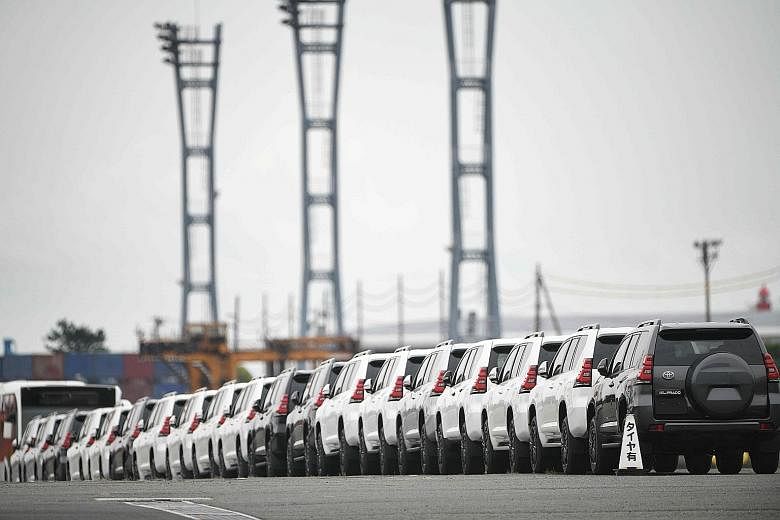 Cars at a pier in Yokohama. Industrial sectors such as cars and oil weighed on overall business sentiment, fanning fears that US President Donald Trump may target auto imports from Japan and other trading partners for protectionist tariffs after impo