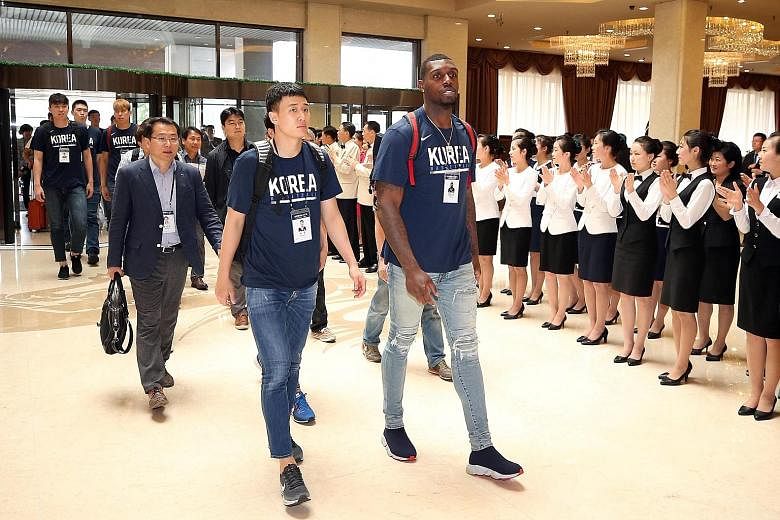 Members of the South Korean men's basketball team being welcomed at the Koryo hotel in Pyongyang yesterday. Unification Minister Cho Myoung-gyon said he hoped the games would "further enhance peace on the Korean peninsula".