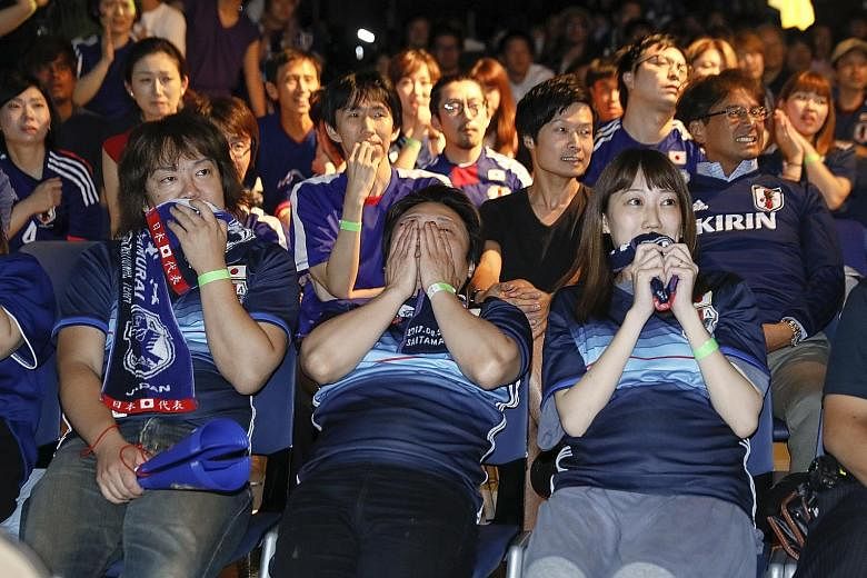 Japanese soccer fans at a public viewing venue in Tokyo were left devastated early yesterday after their team lost to Belgium in a World Cup round-of-16 match. The Samurai Blue looked on track to reach their first quarter-final after going 2-0 ahead,