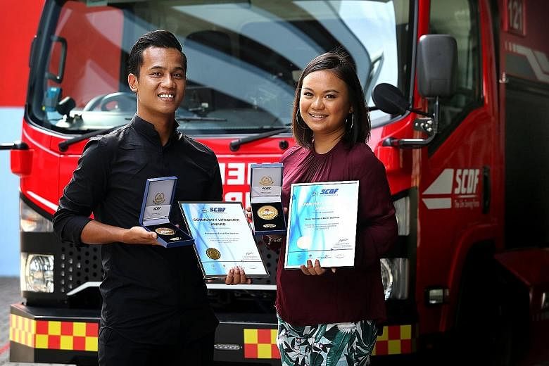 Mr Muhammad Faizal Ibrahim and his girlfriend Noor Hafawati Othman with their Community Lifesaver Awards from SCDF, given in recognition of their public spiritedness.