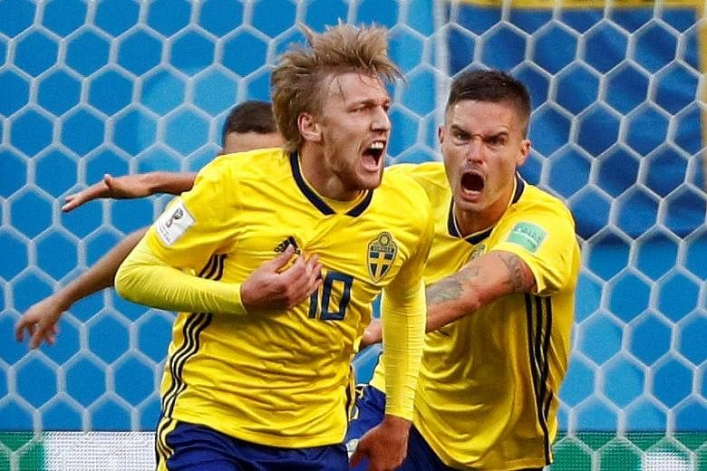 Sweden's Emil Forsberg celebrating with team-mates after scoring the only goal of the round-of-16 game against Switzerland in the 66th minute. He also made a vital contribution at the other end, making a crucial block to prevent a Swiss equaliser bef