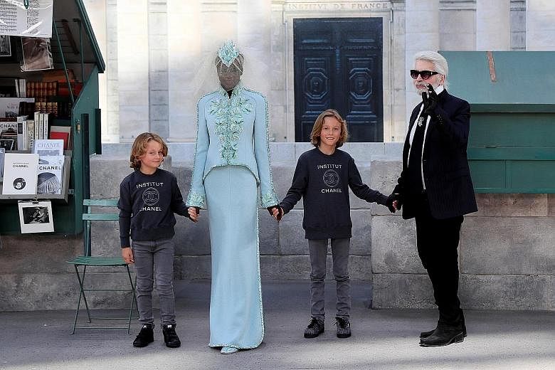 Designer Karl Lagerfeld (right) at his haute couture autumn/winter show for Chanel at the Grand Palais. With him are his godsons Jameson (left) and Hudson Kroenig and South Sudanese-Australian model Adut Akech.