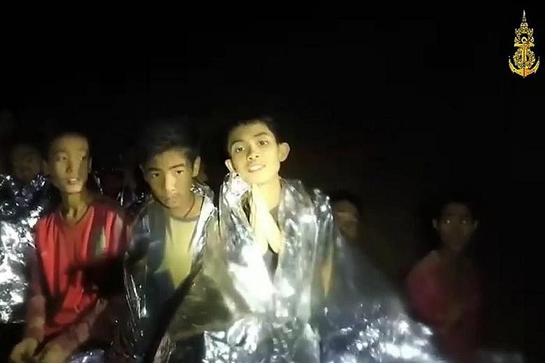 In photos released by the Thai navy Seals, rescue personnel (right and below) are shown working in the Tham Luang cave network to find a way to extract the 12 boys and coach trapped on a small mound more than 4km from the mouth of the cave.