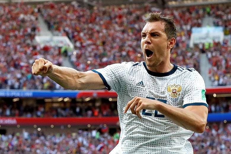 Artem Dzyuba of Russia shows his delight after converting a first-half penalty to equalise against Spain in their round-of-16 match in Moscow on Sunday. The hosts held the 2010 world champions Spain at bay and went on to stun them 4-3 in the penalty 