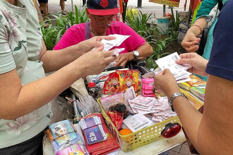 Above: Vendors will still be able to sell Singapore Sweep tickets that will be printed in the new format and delivered to them, said Singapore Pools. Left: The old look of the tickets (foreground) and the new look (background).