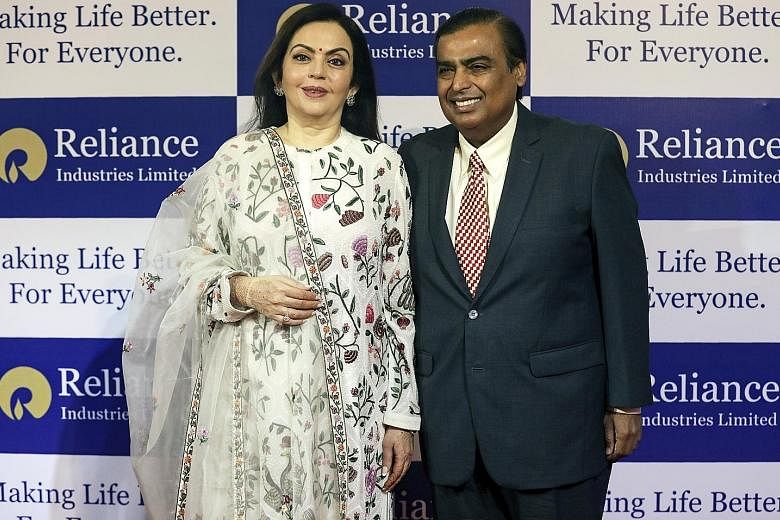 India's richest man Mukesh Ambani, chairman and managing director of Reliance Industries, pictured here with his wife Nita Ambani, has announced plans to expand into fibre-based broadband. Reliance sparked a price war in India's telecoms market when 