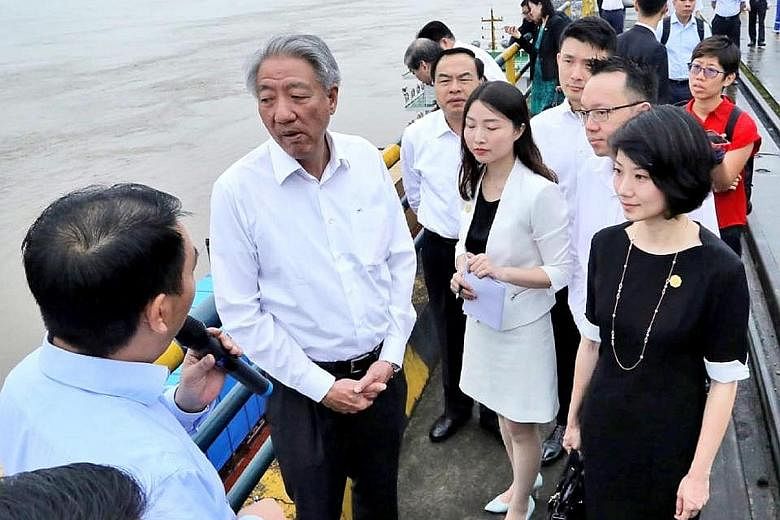 Deputy Prime Minister Teo Chee Hean at Chongqing's Guoyang Port with (from right) Singapore senior parliamentary secretaries Sun Xueling, Tan Wu Meng and Baey Yam Keng (partially obscured).