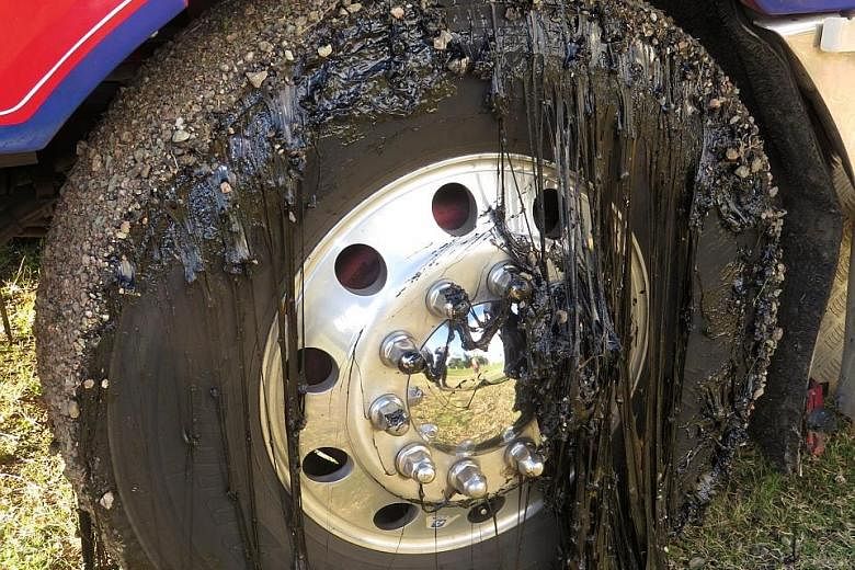 Molten tar on the tyre of a truck in Atherton Tablelands, North Queensland, Australia, yesterday. Hot weather in the area had melted the bitumen and several motorists had to replace their tyres.