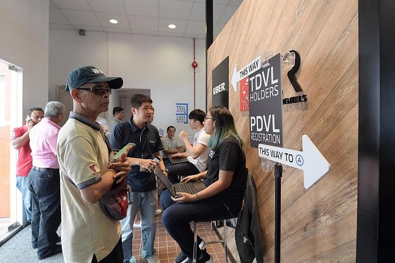 Applicants for the mandatory Private Hire Car Driver's Vocational Licence at UberHub in Paya Lebar in June last year. A one-year concession period was given for them to pass the test for the licence.