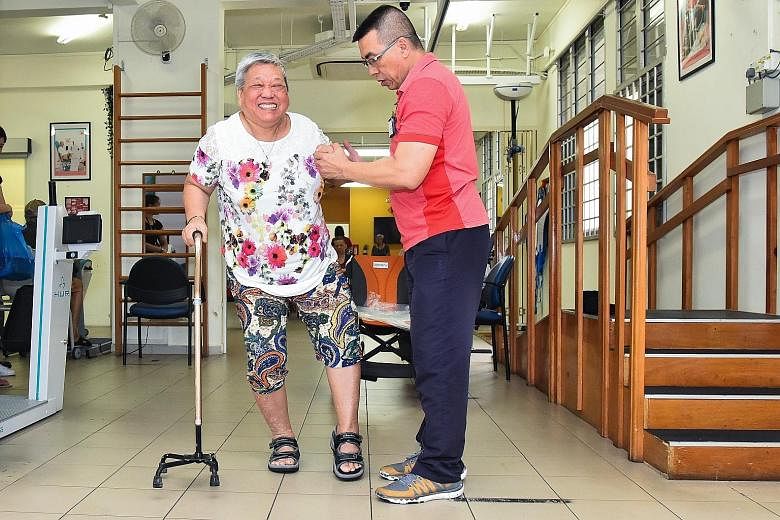 Above: Madam Oei Lian Eng with her husband, Mr Tan Sue Hoai, who is her sole caregiver. Above right: Madam Oei is helped by Mr Colin Teo, 59, in her rehabilitation at The Salvation Army Peacehaven Bedok Multi-Service Centre, where she goes for day ca