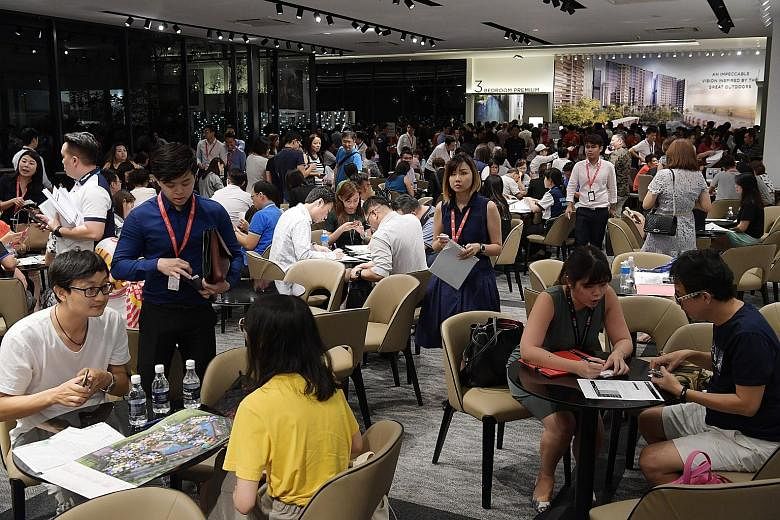 Riverfront Residences' showflat after the property cooling measures kicked in. The Hougang project's original launch date was this weekend, but it was brought forward to allow buyers to lock in deals. The crowd at the Riverfront Residences showflat b