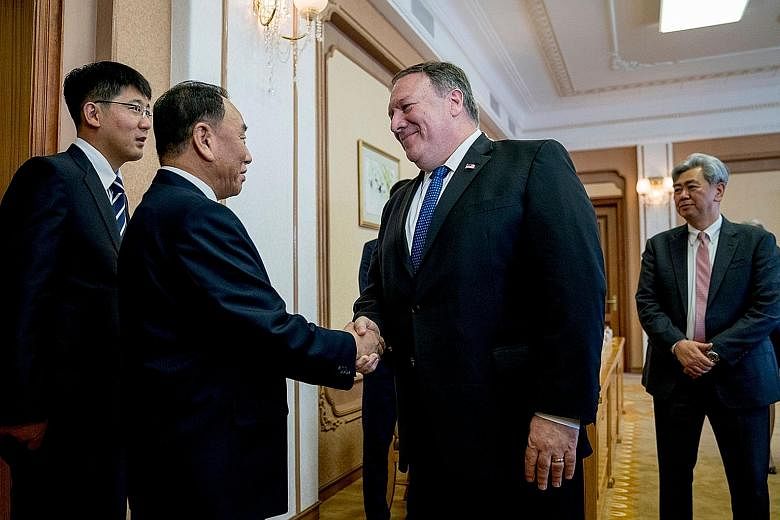 US Secretary of State Mike Pompeo being met by North Korea's director of the United Front Department, Mr Kim Yong Chol, ahead of a meeting at the Park Hwa Guest House in Pyongyang yesterday. Mr Pompeo heads to Japan after his first overnight stay in 