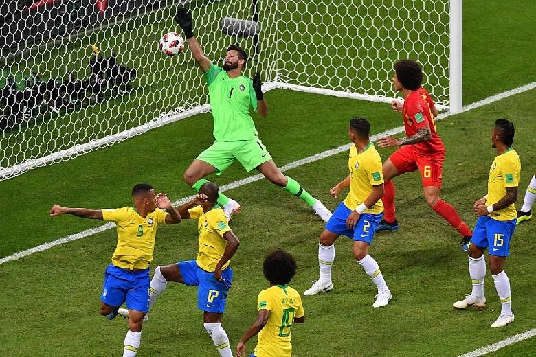 Brazil's goalkeeper Alisson fails to stop an own-goal by team-mate Fernandinho (17), while a distraught Neymar kneels and covers his face after his side are knocked out at the quarter-final stage on Friday. Many pundits believe Neymar's antics played
