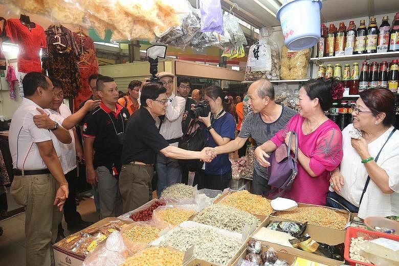 Finance Minister Heng Swee Keat greeting residents on a visit to Kaki Bukit in Aljunied GRC yesterday. Mr Heng launched a voucher scheme for needy families in the ward, where 14 per cent of residents live in rental flats.
