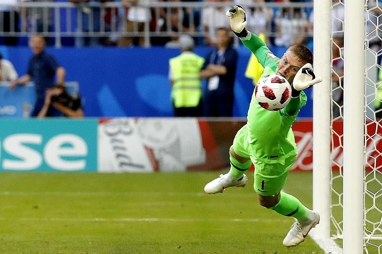 England goalkeeper Jordan Pickford flinging himself at Sweden striker Marcus Berg's goal-bound header early in the second half on Saturday. Had it not been for his heroics, Sweden would have equalised just after the break, but the Three Lions ran out