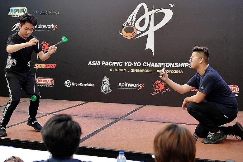 Champion of Champions Arata Imai (left) doing his tricks yesterday, with his performance recorded by Mr Thawrir Iqbal using a phone. The competition drew 161 competitors from 15 countries in the region.