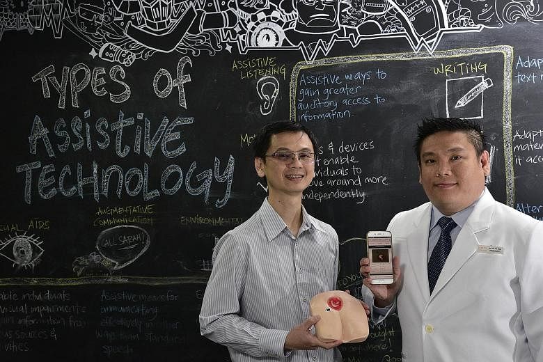 Mr Lim Kwang Yong (far left), whose company Nucleus Dynamics created NDKare, and Dr Tan Jit Seng, who has used the app to manage his patients.