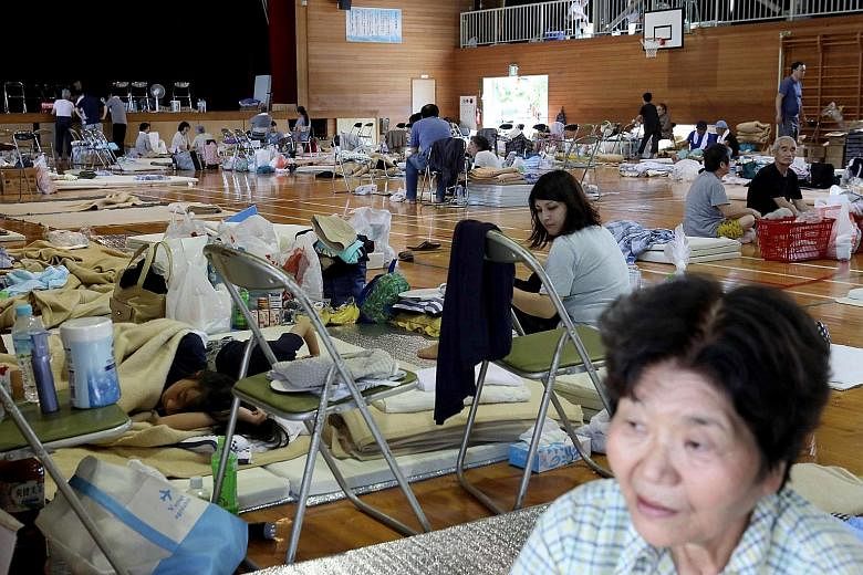 A man in his flood-destroyed home in Kurashiki, Okayama. About 10,000 people in 12 prefectures remain in evacuation centres.