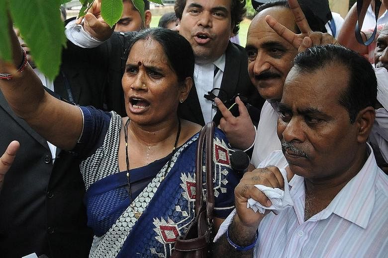 The parents of the victim after India's top court yesterday upheld the death sentence for three assailants in the notorious gang-rape and murder of the young college student in 2012.