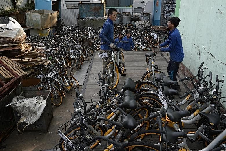 Workers unloading oBike bicycles meant for recycling last week. The bike-sharing company announced it was ceasing its operations here two weeks ago.